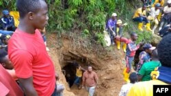 FILE - Rescuers work in Kamituga, South Kivu, on Sept. 12, 2020, at the entrance of one of the mines where dozens of Congolese artisanal miners are feared to be killed after heavy rain filled the mine tunnels.