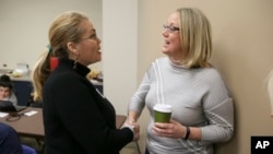 FILE - EMILY's List President Stephanie Schriock, right, speaks to Brandy K. Chambers, a candidate for a Texas House of Representatives seat, during a candidate training workshop for women at El Centro College in Dallas. EMILY'S List, an organization dedicated to electing candidates at all levels of government who support abortion rights, is conducting a national recruitment effort looking to train candidates and potential candidates in over 20 states.