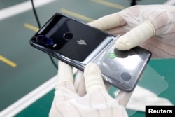 A manufacturer works at an assembly line of Vingroup's Vsmart phone in Hai Phong, Vietnam, Dec. 4, 2018.