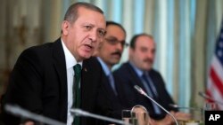 Turkish President Recep Tayyip Erdogan speaks during a bilateral meeting with President Barack Obama, in Paris, on Dec. 1, 2015.