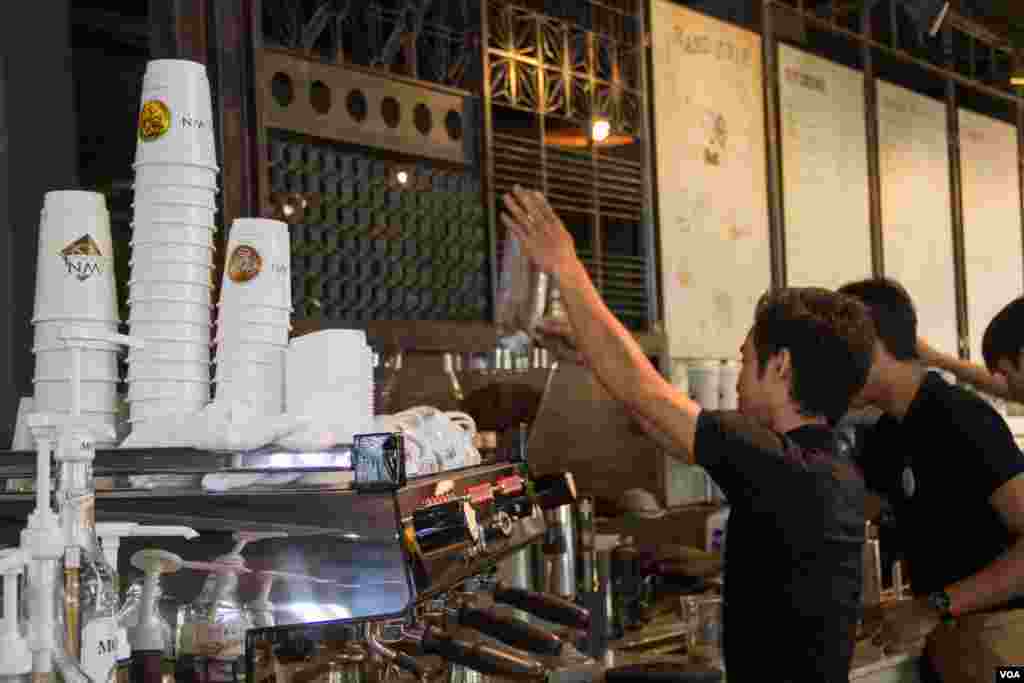 A staff is pouring coffee bean into grinder machine at Coffee Brown Roastery on 27th February 2015.&nbsp;