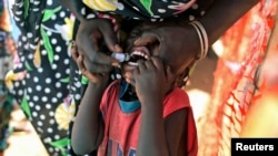 FILE - Displaced South Sudanese child receives oral cholera vaccine in a camp for internally displaced people in Juba, Feb. 2014.