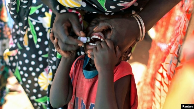 FILE - Displaced South Sudanese child receives oral cholera vaccine in a camp for internally displaced people in Juba, Feb. 2014.
