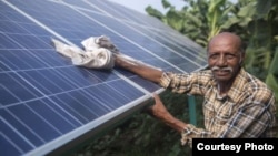 Ramanbhai Parmar, has become the first farmer to sell energy back to the power grid from the solar panels that drive his water pump in Anand district, Gujrat, India, June 8, 2015. (International Water Management Institute photo, Prashanth Vishwanathan)