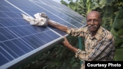 Ramanbhai Parmar has become the first farmer to sell energy back to the power grid from the solar panels that drive his water pump in Anand district, Gujrat, India, June 8, 2015. (International Water Management Institute photo, Prashanth Vishwanathan)