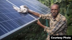 Ramanbhai Parmar, has become the first farmer to sell energy back to the power grid from the solar panels that drive his water pump in Anand district, Gujrat, India, June 8, 2015. (International Water Management Institute photo, Prashanth Vishwanathan)