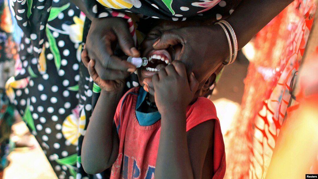 FILE - A displaced South Sudanese child receives an oral cholera vaccine in a camp for internally displaced people in the United Nations Mission in South Sudan compound in Tomping, Juba, Feb. 2014.