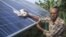 Ramanbhai Parmar, has become the first farmer to sell energy back to the power grid from the solar panels that drive his water pump in Anand district, Gujrat, India, June 8, 2015. (International Water Management Institute photo, Prashanth Vishwanathan)