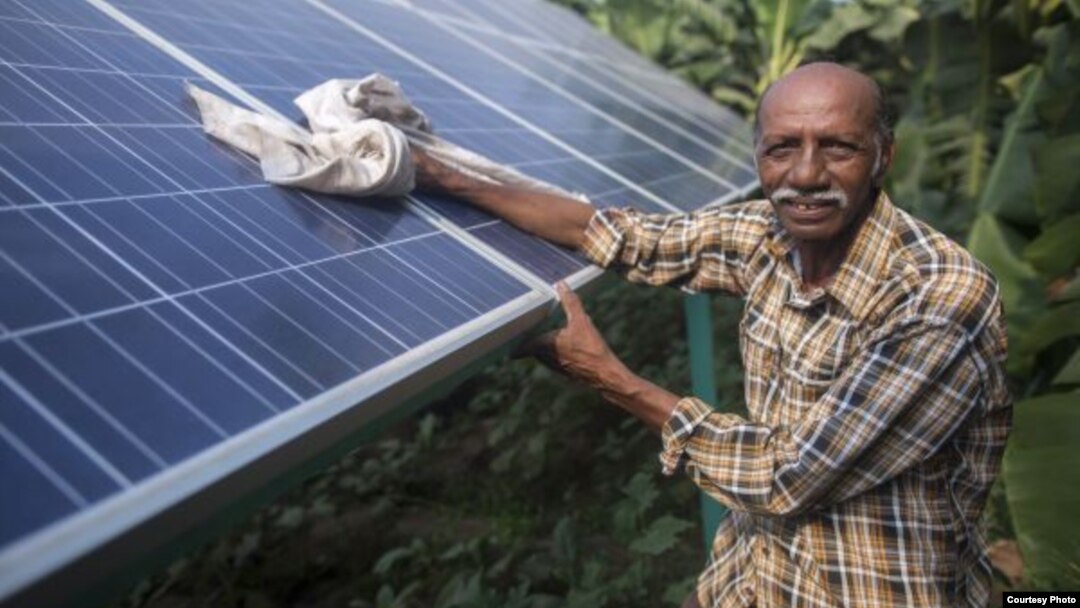 Ramanbhai Parmar, has become the first farmer to sell energy back to the power grid from the solar panels that drive his water pump in Anand district, Gujrat, India, June 8, 2015. (International Water Management Institute photo, Prashanth Vishwanathan)