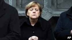 German Chancellor Angela Merkel, attends the opening of a memorial in Berlin, Dec. 19, 2017, to honor the victims of the Christmas market terrorist attack.