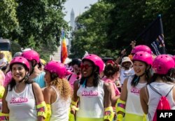 Marchers dressed up to promote the Barbie movie prepare for the start of the Capital Pride Parade in Washington, DC, on June 10, 2023.