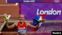 FILE - Russia's Yulia Zaripova celebrates after winning the women's 3000-meter steeplechase final at the London 2012 Olympic Games at the Olympic Stadium, Aug. 6, 2012. 