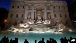 FILE - Trevi Fountain is lit after its restoration in Rome, Nov. 3, 2015. 