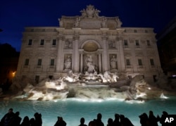 FILE - The newly restored Trevi Fountain is lit during the official inauguration in Rome, Italy, Nov. 3, 2015.