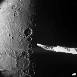 This image provided by European Space Agency shows close-up photos of Mercury's north pole taken by the European-Japanese spacecraft BepiColombo. (European Space Agency via AP)