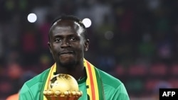 FILE: Senegal's forward Sadio Mane holds the trophy prior to the ceremony after winning after the Africa Cup of Nations (CAN) 2021 final football match between Senegal and Egypt at Stade d'Olembe in Yaounde on 2.6.2022