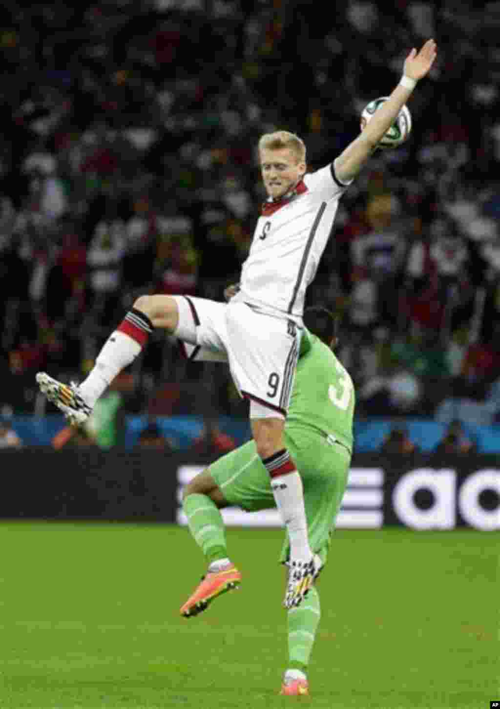 Germany's Andre Schuerrle jumps above Algeria's Faouzi Ghoulam during the World Cup round of 16 soccer match between Germany and Algeria at the Estadio Beira-Rio in Porto Alegre, Brazil, Monday, June 30, 2014. (AP Photo/Sergei Grits)