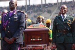 The coffin carrying the remains of former Zimbabwean leader Robert Mugabe arrives at the National Sports stadium during a funeral procession in Harare, Sept, 14, 2019.