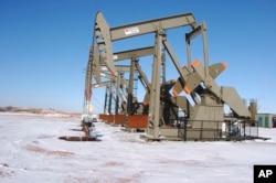 FILE - This Feb. 26, 2015, file photo, shows an oil well on the Fort Berthold Indian Reservation near Mandaree, North Dakota. Interior Secretary Ryan Zinke announced plans July 6, 2017, to encourage oil and gas development on federal lands with faster and simpler permitting and more frequent sales of government drilling rights.