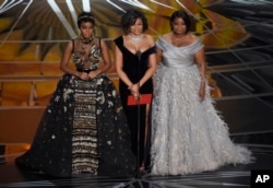 Janelle Monae, from left, Taraji P. Henson, and Octavia Spencer present the award for best documentary feature at the Oscars on Feb. 26, 2017, at the Dolby Theatre in Los Angeles.