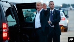 U.S. President Donald Trump yells to reporters after arriving at Andrews Air Force Base after a summit with North Korean leader Kim Jong Un in Singapore, June 13, 2018, in Andrews Air Force Base, Md. 