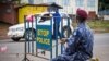 Police guard a roadblock as Sierra Leone government enforces a three day lock down on movement of all people in an attempt to fight the Ebola virus in Freetown, Sierra Leone, Sept. 19, 2014. 