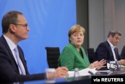 German Chancellor Angela Merkel attends a news conference after a meeting with state leaders to discuss options beyond the end of the pandemic lockdown, amid the outbreak of the coronavirus disease (COVID-19), in Berlin, Germany, March 23, 2021.