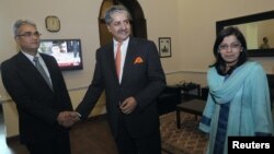 In this file photo, Pakistani Defense Minister Naveed Qamar is seen flanked by Indian and Pakistani officials, Rawalpindi, June 11, 2012.