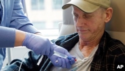 FILE - A lymphoma patient receives cellular immunotherapy as part of a study at the Fred Hutchinson Cancer Research Center in Seattle, Washington.