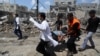 Palestinian medics carry a man injured in Gaza City's Shijaiyah neighborhood that came under fire as Israel widened its ground offensive against Hamas in the northern Gaza Strip, July 20, 2014.