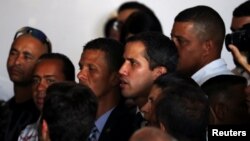 Venezuelan opposition leader Juan Guaido, whom many nations have recognized as the country's rightful interim ruler, sings the national anthem during a meeting about water and electricity systems in Caracas, Venezuela, March 28, 2019.