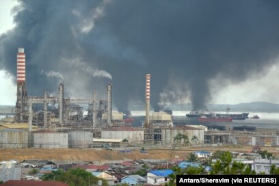 Asap tebal mengepul dari kebakaran akibat tumpahan minyak di perairan Balikpapan, Kalimantan Timur, 31 Maret 2018. (Foto: Antara/Sheravim via REUTERS)