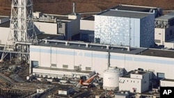 An aerial view shows the quake-damaged Fukushima nuclear power plant in the Japanese town of Futaba, Fukushima prefecture, Japan, run by Tokyo Electric Power, March 12, 2011