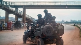 FILE - In this Jan. 14, 2021, file photo, security forces patrol the streets on election day in Kampala, Uganda.