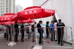 Residents line up outside a vaccination center in Beijing on June 2, 2021.