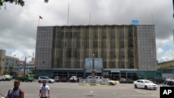 People walk near the central bank in Georgetown, Guyana, where the discovery of major oil and gas deposits offshore in the Atlantic have ignited hope that one of the poorest countries in the Western Hemisphere will undergo an economic transformation.