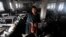 Bangladeshi garment worker Laiju stands inside the damaged Smart Export Garment Ltd. factory where a fire Saturday claimed the lives of seven of her female colleagues in Dhaka, Bangladesh, Sunday, Jan. 27, 2013.