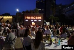 FILE —People attend a seder in support of hostages kidnapped in the deadly October 7 attack, in Tel Aviv, April 22, 2024.