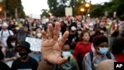 Demonstrators protest, Friday, June 5, 2020, near the White House in Washington, over the death of George Floyd, a black man who was in police custody in Minneapolis. 