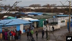 Converted shipping containers are placed at the entrance of the Calais refugee camp. Some refugees tried to force their way aboard a British ferry at the port city. 