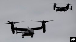 FILE — U.S. Marine Corps V-22 Osprey aircraft approach John F. Kennedy International Airport in New York, Sept. 25, 2014. A V-22 Osprey crashed off western Japan during training last week. Remains of six of the eight crew members aboard the aircraft have been recovered so far.
