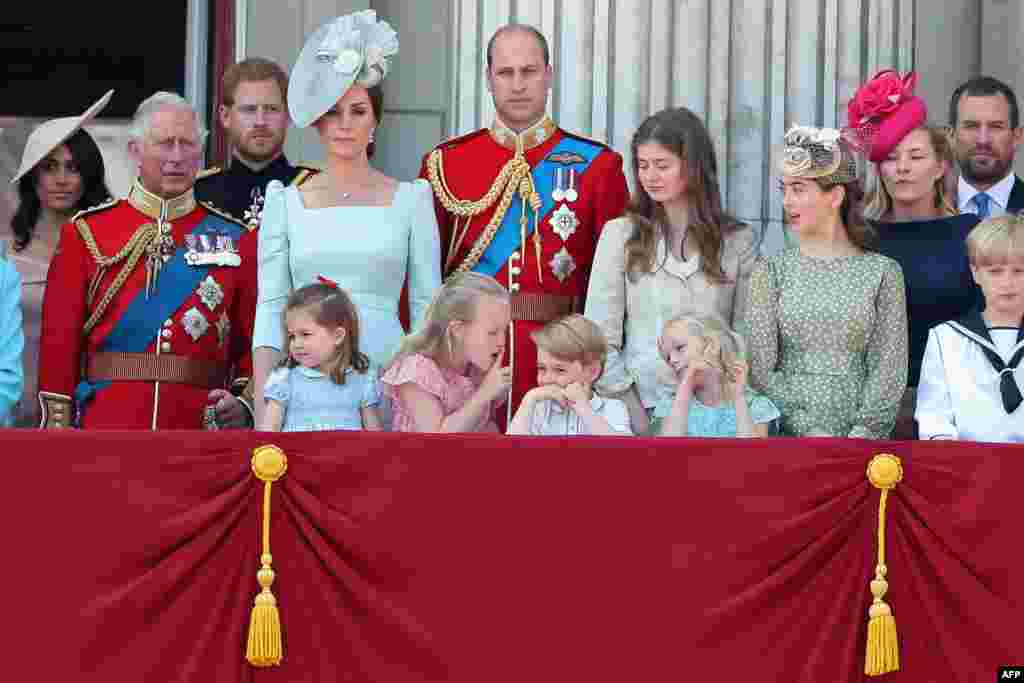 In the front row (L-R), children, Princess Charlotte of Cambridge, Savannah Phillips, Prince George of Cambridge and Isla Phillips chat on the balcony of Buckingham Palace as members of the Royal Family gather to watch a fly-past of aircraft by the Royal Air Force, in London, June 9, 2018.