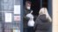 A man wearing a face mask carries a takeaway lunch from a restaurant in Bratislava, Slovakia, Nov. 25, 2021. The Slovak government approved a two-week national lockdown amid a record surge of coronavirus infections.