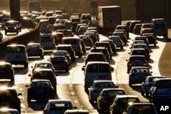 FILE - Morning rush hour traffic makes its way along US 101 near downtown Los Angeles, California, Nov. 15, 2016.