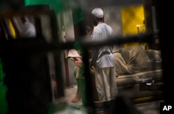 This June 6, 2018 photo, reviewed by US military officials, shows detainees inside the Camp 6 detention facility at Guantanamo Bay U.S. Naval Base, Cuba.