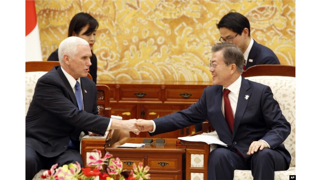 U.S. Vice President Mike Pence, left, shakes hands with South Korean President Moon Jae-in during their meeting at the presidential office Blue House in Seoul, Feb. 8, 2018.