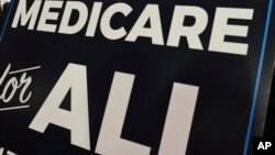 FILE - A sign is shown during a news conference to reintroduce "Medicare for All" legislation, on Capitol Hill in Washington, April 10, 2019.
