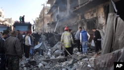 28일 연쇄 폭탄 테러가 발생한 시리아 홈스 지역에 소방대원들이 출동했다.