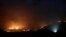 A wildfire threatening property glows on the hills south of the Australian capital, Canberra, Jan. 31, 2020. The blaze on Canberra's southern fringe has razed more than 21,500 hectares (53,000 acres) since it was sparked Monday.