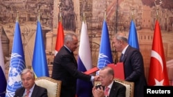 Russia's Defense Minister Sergei Shoigu and Turkish Defense Minister Hulusi Akar shake hands next to U.N. Secretary-General Antonio Guterres and Turkish President Recep Tayyip Erdogan during a signing ceremony in Istanbul, Turkey. 7.22.2022